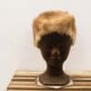 Chic tan faux fur hat for women, blending vintage style with modern elegance.
