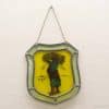 Traditional woman balancing harvest in vibrant stained glass art piece celebrating agricultural life.