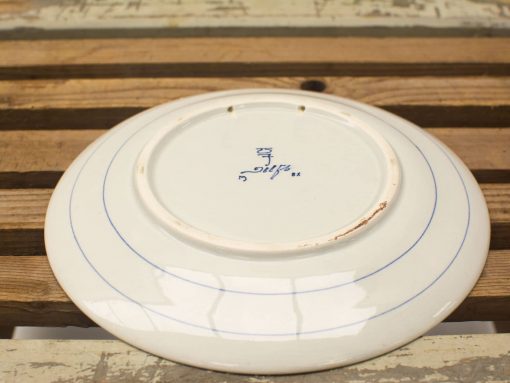 Classic vintage porcelain plate with blue accents and elegant hand-painted makers mark.