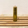 Polished brass cylinder on rustic wood, embodying vintage charm and craftsmanship.