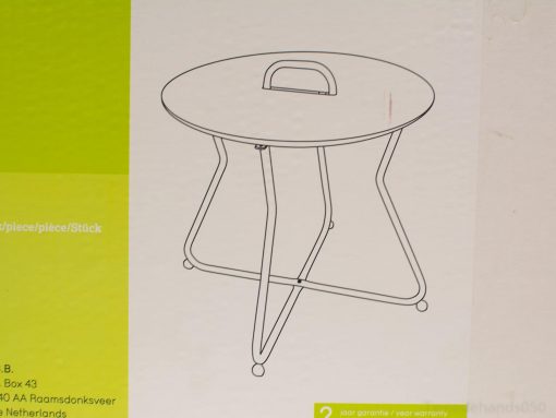Stylish minimalist round table with handle and slim legs for versatile indoor and outdoor use.