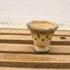 Elegant ceramic vessel in earthy tones with unique hand-painted patterns for charming decor.