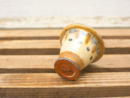 Elegant vintage ceramic cup with colorful patterns and a golden rim, perfect for any collection.
