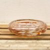 Elegant handblown glass bowl in amber and white, perfect for decor or daily use.