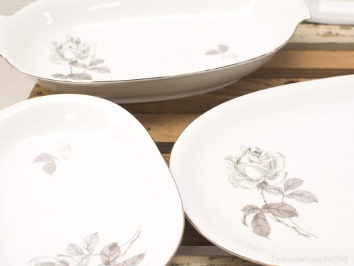 Elegant vintage ceramic dishes with lavender rose design for timeless dining experiences.