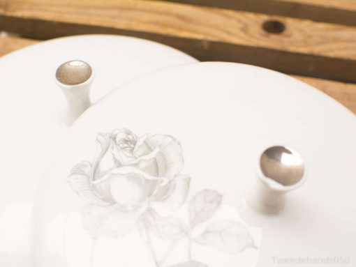 Elegant vintage porcelain serving dishes with rose design, perfect for stylish dining occasions.