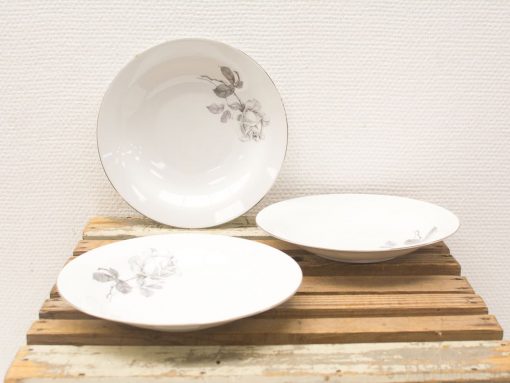 Elegant vintage porcelain dinnerware set featuring delicate rose designs. Perfect for stylish dining.