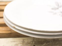 Elegant vintage Wedgwood plates with gold trim and floral motifs for charming table settings.