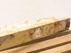 Vintage wooden spirit level with a weathered look, perfect for accurate leveling and craftsmanship.