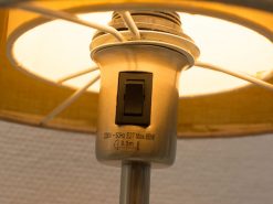 Vintage table lamp with warm glow, E27 socket, and polished metallic finish for cozy ambiance.