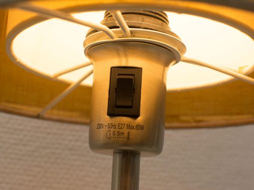 Vintage table lamp with warm glow, E27 socket, and polished metallic finish for cozy ambiance.