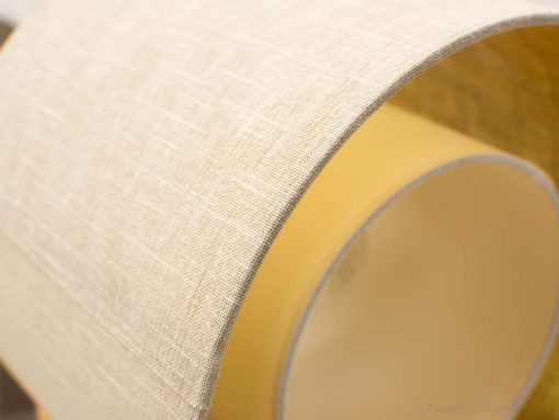 Elegant cream and beige lampshade with woven texture, perfect for various decor styles.