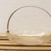 Elegant vintage glass basket with engraved design and a sleek metallic handle.