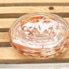 Elegant glass dish with vibrant red and white design, perfect for decor or everyday use.