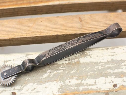 Vintage pastry wheel by Schelleken, perfect for creating decorative edges on baked goods.