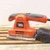 Used BLACK+DECKER electric sander with dust bag, ideal for DIY and professional projects.