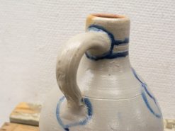 Handcrafted ceramic jug with blue patterns, showcasing rustic charm and elegant design.