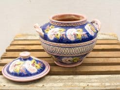 Handcrafted vibrant blue ceramic pot with lid and floral design, perfect for decor or storage.