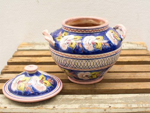Handcrafted vibrant blue ceramic pot with lid and floral design, perfect for decor or storage.