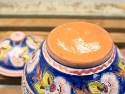 Vibrant handcrafted ceramic bowl with floral pattern, perfect for decor and functionality.