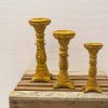 Elegant gold candle holders set with intricate designs, perfect for enhancing any decor.