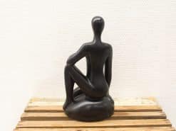 Elegant minimalist black sculpture of a seated figure, perfect for modern interior decor.