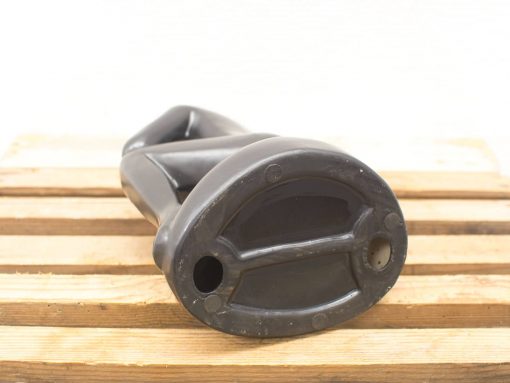 Elegant black sculpture on rustic wooden surface, blending modern design with natural elements.