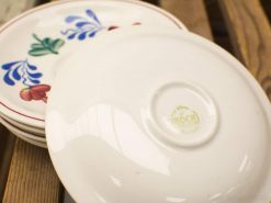Vintage ceramic plates with colorful floral designs, perfect for elegant table settings.