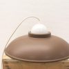 Elegant brown vintage lamp with a contrasting white dome, perfect for stylish interiors.