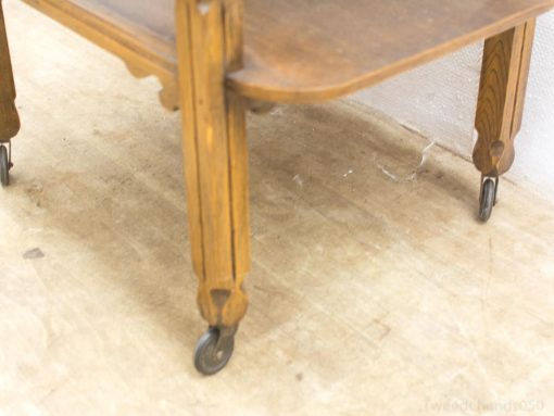 Elegant vintage wooden table with wheels, perfect for a timeless and functional decor.