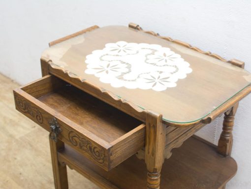 Vintage wooden side table with intricate inlay, elegant design, and functional storage drawer.