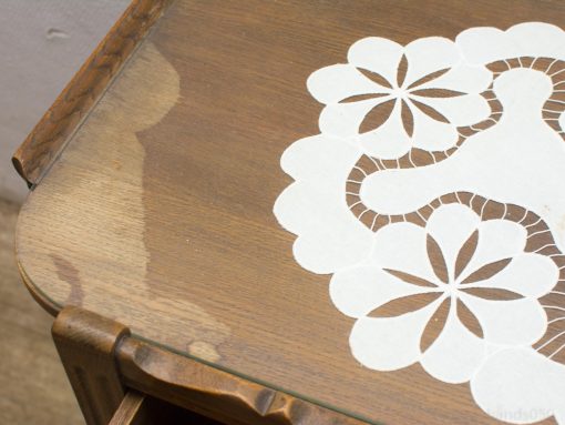 Elegant wooden table with lace doily adds warmth and charm to any decor.