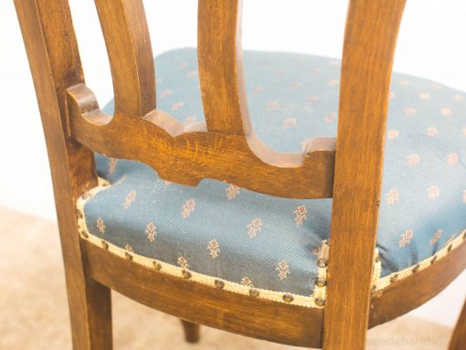 Elegant wooden chair with blue upholstery, perfect for any interior style.