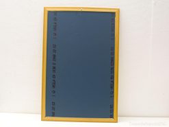 Stylish blue bulletin board with light wood frame, perfect for notes and photos.