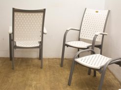 Modern chairs with elegant perforated backs, perfect for stylish indoor and outdoor settings.