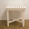 Elegant white wooden table with slatted design, perfect for versatile interior styles.