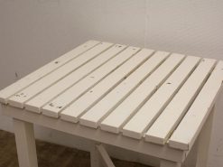 Rustic vintage wooden table with slatted design, perfect for casual indoor or outdoor settings.