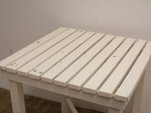 Rustic vintage wooden table with slatted design, perfect for casual indoor or outdoor settings.
