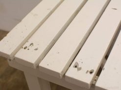 Stylish white wooden table with character, perfect for dining or crafting in any space.