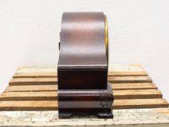 Elegant vintage wooden clock with polished finish and brass bezel, perfect for classic decor.
