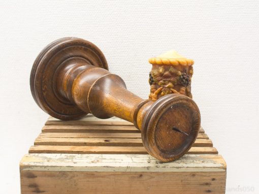 Rustic wooden candlestick with vibrant decorative candle, perfect for cozy home decor.