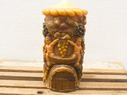 Whimsical tower candle featuring cherubs and grapes, perfect for adding charm and nostalgia.