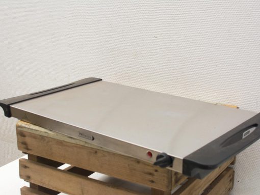 Durable stainless steel griddle with heat-resistant handles on a rustic wooden pallet.