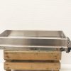 Stainless steel electric grill on wooden base, perfect for outdoor barbecues and gatherings.