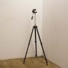 Classic vintage tripod with adjustable mount for photographers and videographers, ensuring stability and creativity.