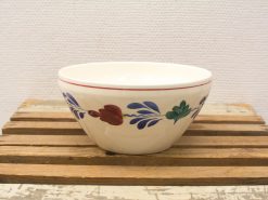 Elegant ceramic flower bowl with a glossy finish on a rustic wooden surface.