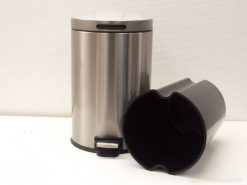 Sleek stainless steel trash can with foot pedal and durable inner liner for elegant waste management.