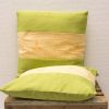 Elegant green and cream decorative cushions for a cozy, modern interior design.