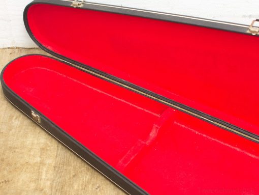 Elegant black instrument case with luxurious red lining for violins and accessories.