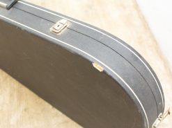 Vintage black guitar case exuding character and musical history with durable craftsmanship.